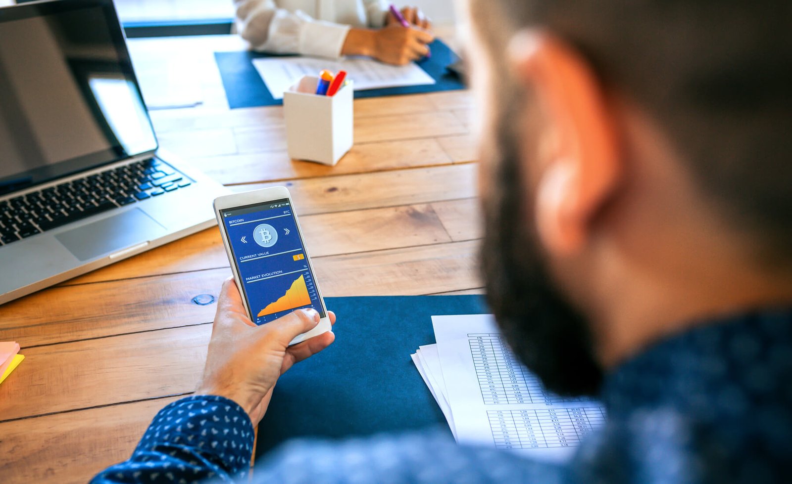 businessman-looking-mobile-with-bitcoins-informati-2023-11-27-05-12-54-utc